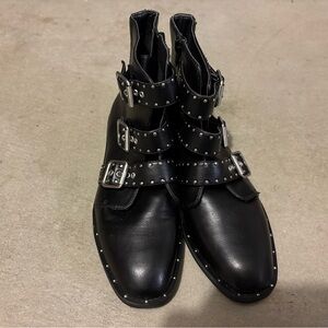 Black studded ankle boots with side buckles.